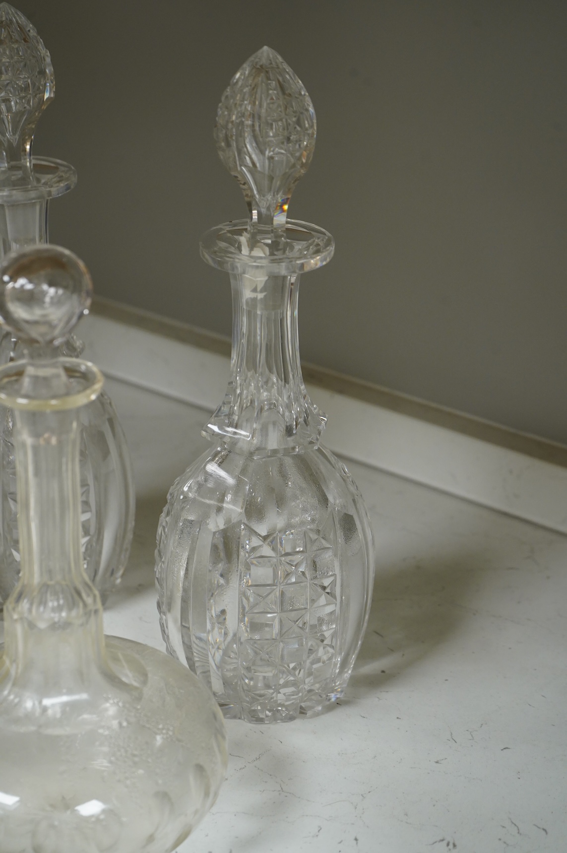 A set of four 19th century Bristol green glasses, an early 19th century spirit decanter and other Victorian decanters